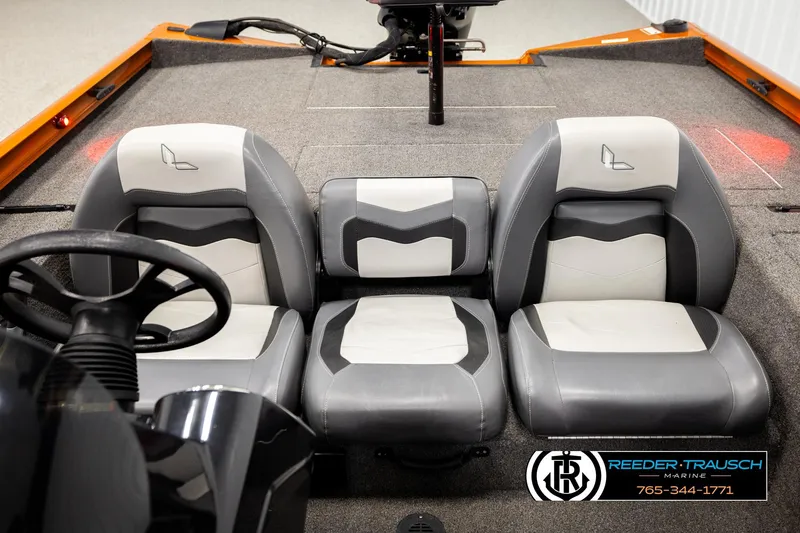 Slide: The Image of 2022 Lowe Stinger 178 boat interior with gray and white seating, steering wheel, and carpeted floor. - 20