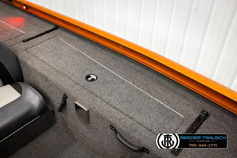 Slide: The Image of 2022 Lowe Stinger 178 boat interior with gray carpet and orange trim. - 22