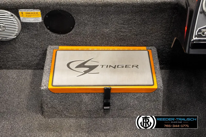 Slide: The Image of 2022 Lowe Stinger 178 boat interior with branded storage compartment and speaker. - 24