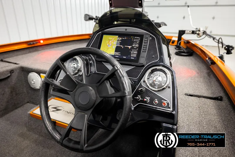 Slide: The Image of 2022 Lowe Stinger 178 boat dashboard with steering wheel and navigation display. - 26