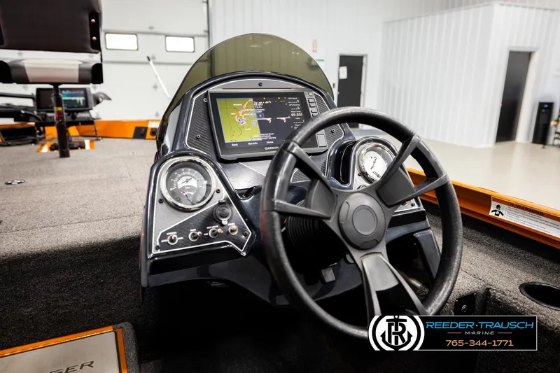 Slide: The Image of 2022 Lowe Stinger 178 boat dashboard with steering wheel and Garmin navigation display. - 27