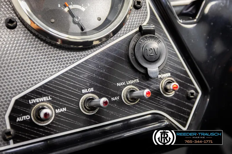 Slide: The Image of Control panel of 2022 Lowe Stinger 178 boat with switches and 12V outlet. - 28