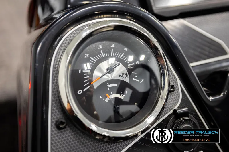 Slide: The Image of Close-up of 2022 Lowe Stinger 178 tachometer, showing RPM gauge and Reeder-Trausch Marine logo. - 29