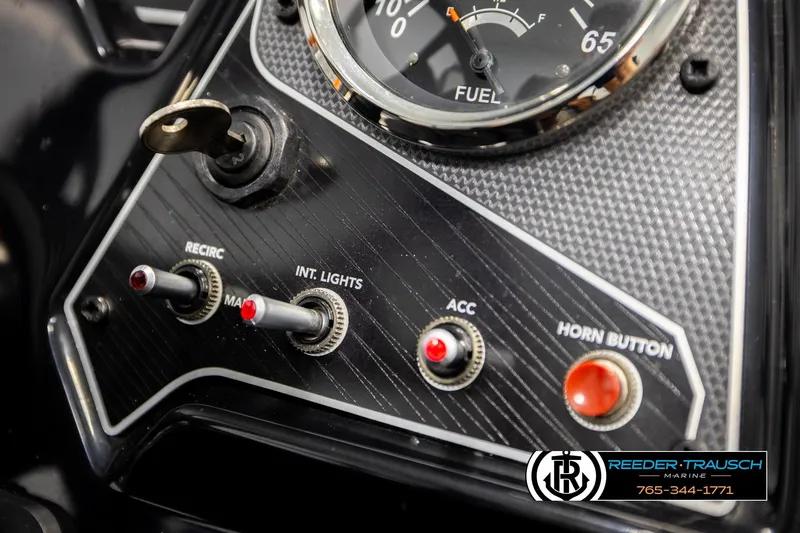 Slide: The Image of Control panel of 2022 Lowe Stinger 178 boat with switches and fuel gauge. - 32