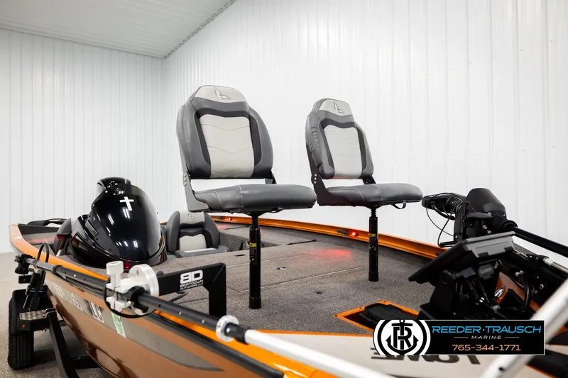 Slide: The Image of 2022 Lowe Stinger 178 boat with dual seats and motor in a showroom. - 52