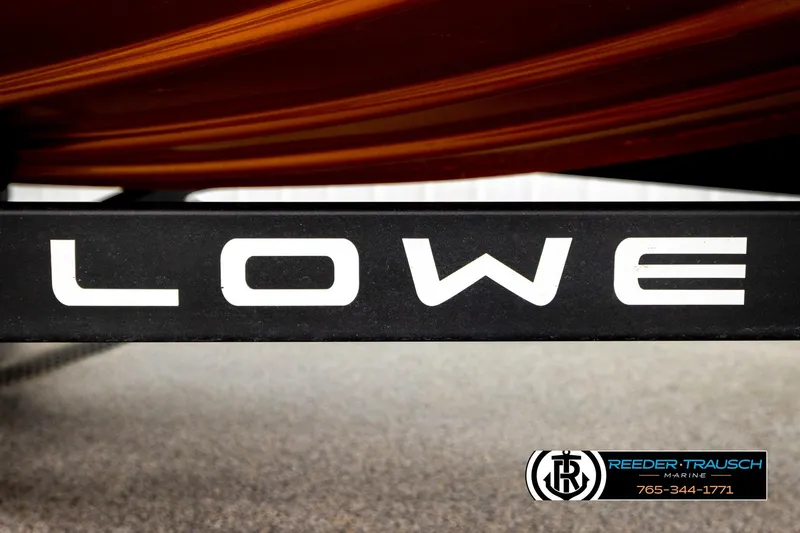 Slide: The Image of Close-up of 2022 Lowe Stinger 178 boat branding with Reeder-Trausch Marine logo. - 56