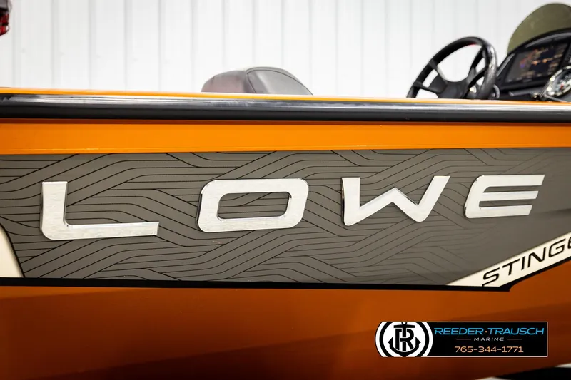 Slide: The Image of 2022 Lowe Stinger 178 boat side view with logo and steering wheel. - 57