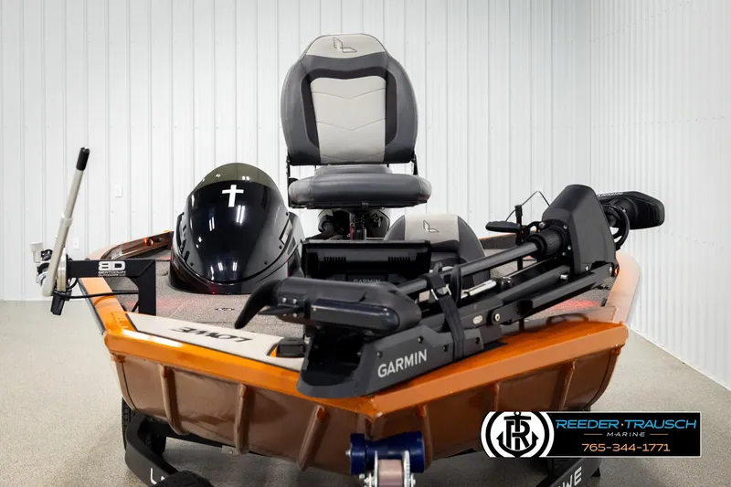 Slide: The Image of 2022 Lowe Stinger 178 boat with Garmin equipment in showroom, Reeder-Trausch Marine branding visible. - 6