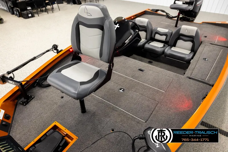 Slide: The Image of 2022 Lowe Stinger 178 boat interior with seating and control panel, showcased by Reeder-Trausch Marine. - 8