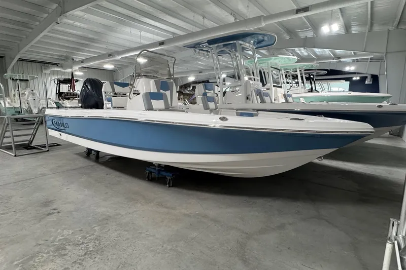 The Image of 2026 Robalo 206 Cayman boat in showroom, blue and white design, indoor display. - 1