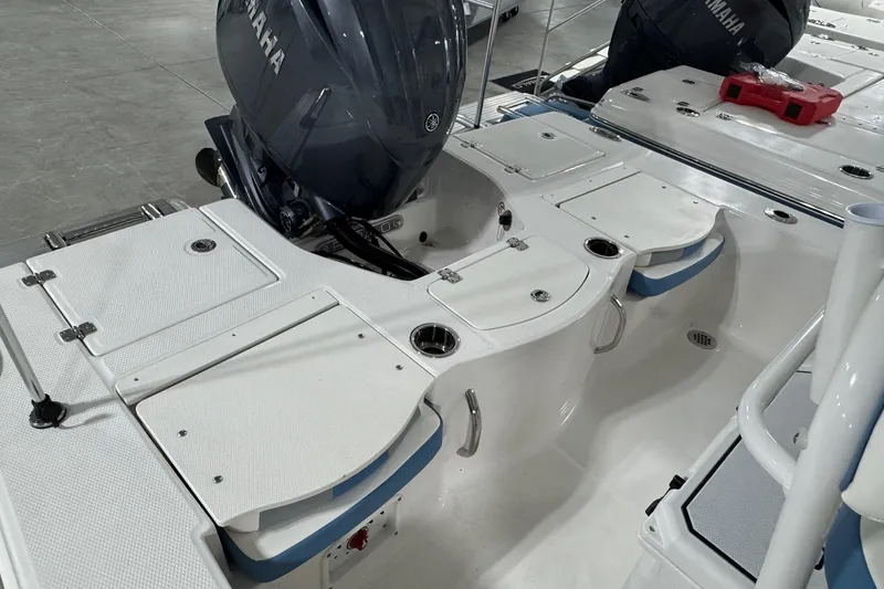 Slide: The Image of 2026 Robalo 206 Cayman boat interior with Yamaha engine, featuring storage compartments and seating. - 7