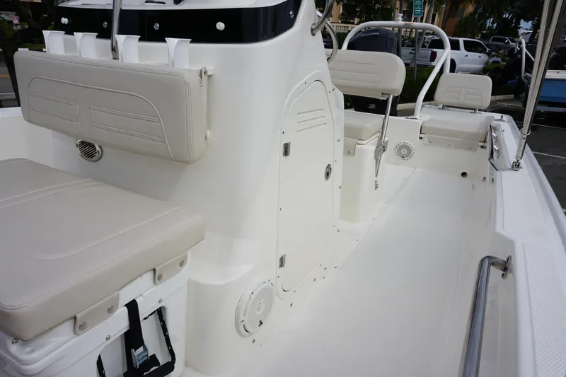 Slide: The Image of 2026 Boston Whaler 190 Montauk boat interior with beige seating and storage compartments. - 17