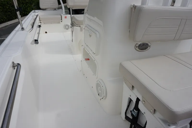 Slide: The Image of 2026 Boston Whaler 190 Montauk interior with white seating and storage compartments. - 18