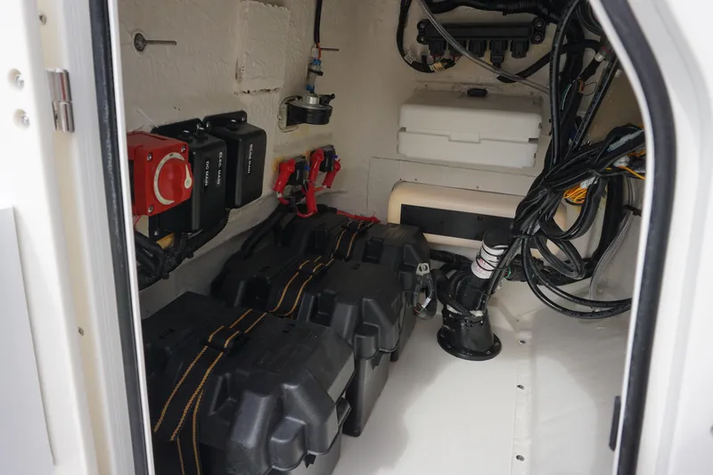 Slide: The Image of 2026 Boston Whaler 190 Montauk interior wiring and battery compartment view. - 19