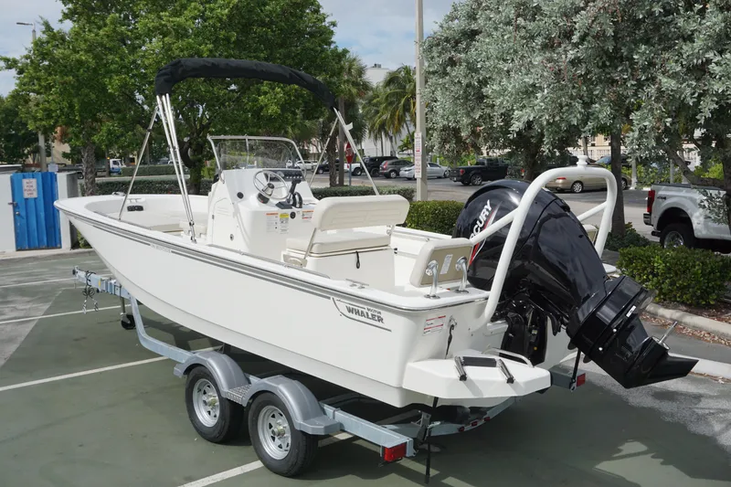 Slide: The Image of 2026 Boston Whaler 190 Montauk boat on trailer in parking lot. - 2