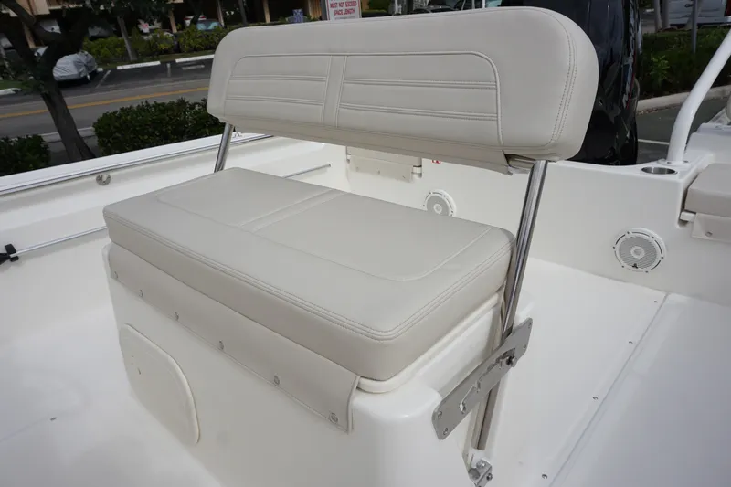Slide: The Image of 2026 Boston Whaler 190 Montauk boat seat with white upholstery and stainless steel frame. - 20