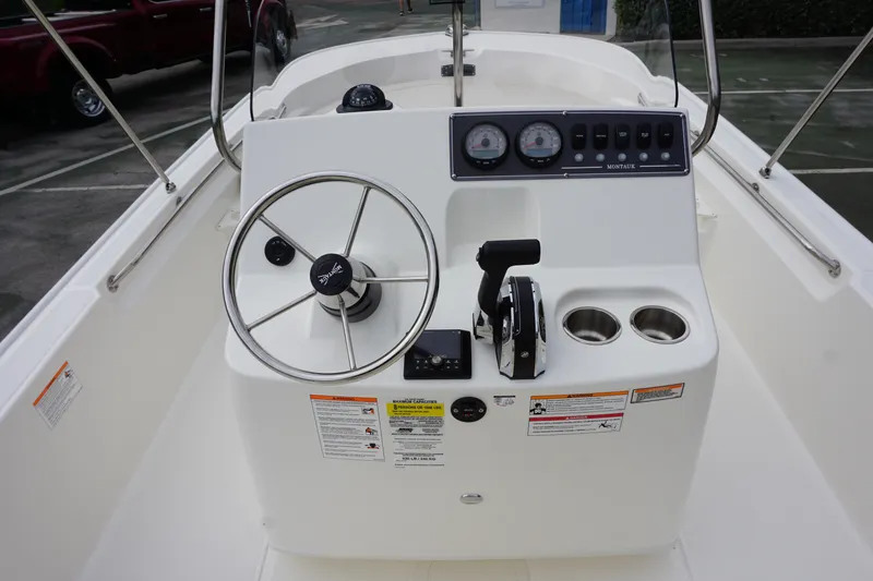 Slide: The Image of 2026 Boston Whaler 190 Montauk boat console with steering wheel and controls. - 6