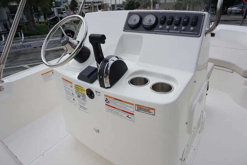 Slide: The Image of 2026 Boston Whaler 190 Montauk boat console with steering wheel and controls. - 7