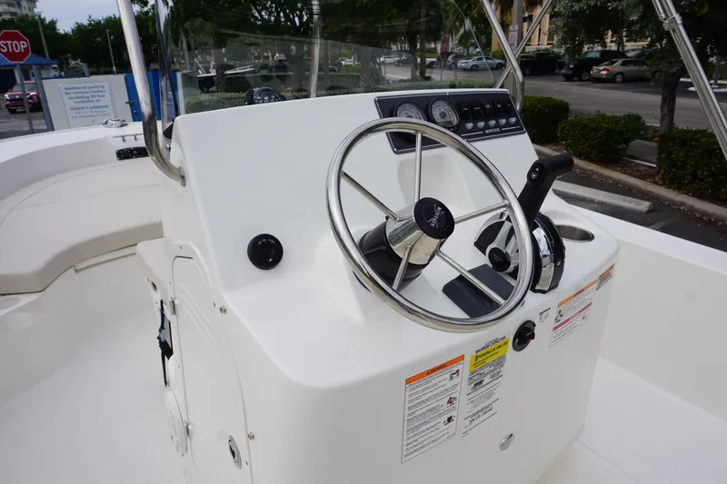 Slide: The Image of 2026 Boston Whaler 190 Montauk boat console with steering wheel and controls. - 8