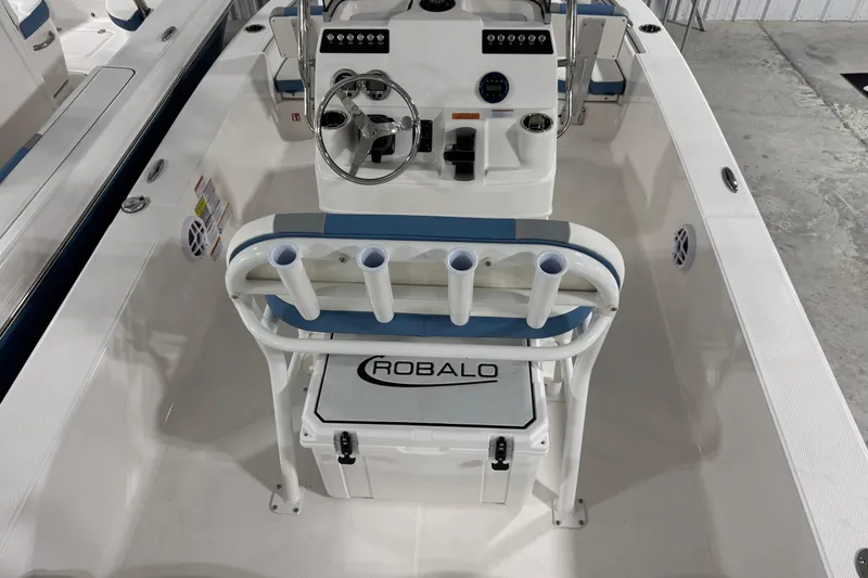 Slide: The Image of 2026 Robalo 206 Cayman boat interior with steering console and rod holders. - 13