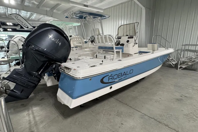 Slide: The Image of 2026 Robalo 206 Cayman boat with Yamaha engine in a showroom. - 2