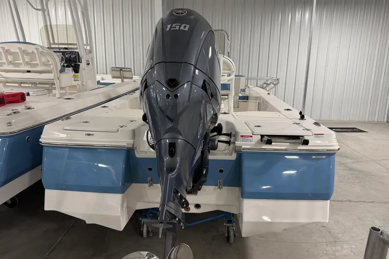 Slide: The Image of 2026 Robalo 206 Cayman boat with Yamaha 150 outboard motor in a showroom. - 3