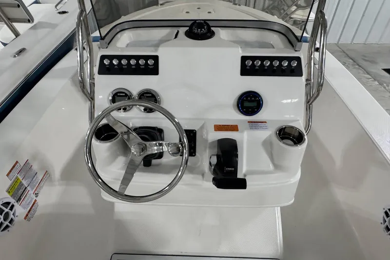 Slide: The Image of 2026 Robalo 206 Cayman boat dashboard with steering wheel and controls. - 6
