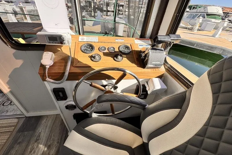 Slide: The Image of 1984 Boatel Hercules boat cockpit with steering wheel, gauges, and radio equipment. - 11