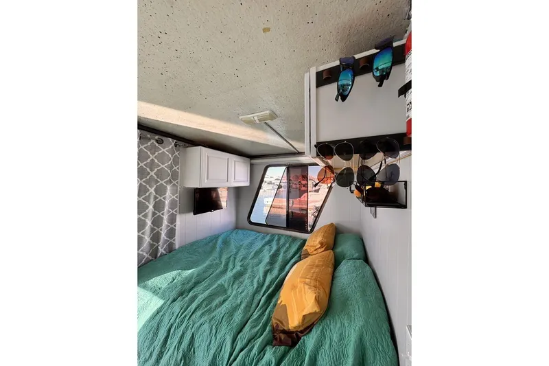 Slide: The Image of Cozy interior of 1984 Boatel Hercules with bed, window, and storage. - 12