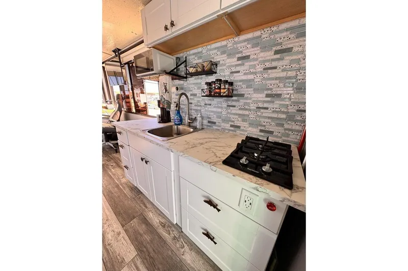 Slide: The Image of Modern kitchen in 1984 Boatel Hercules with marble countertop and gas stove. - 19