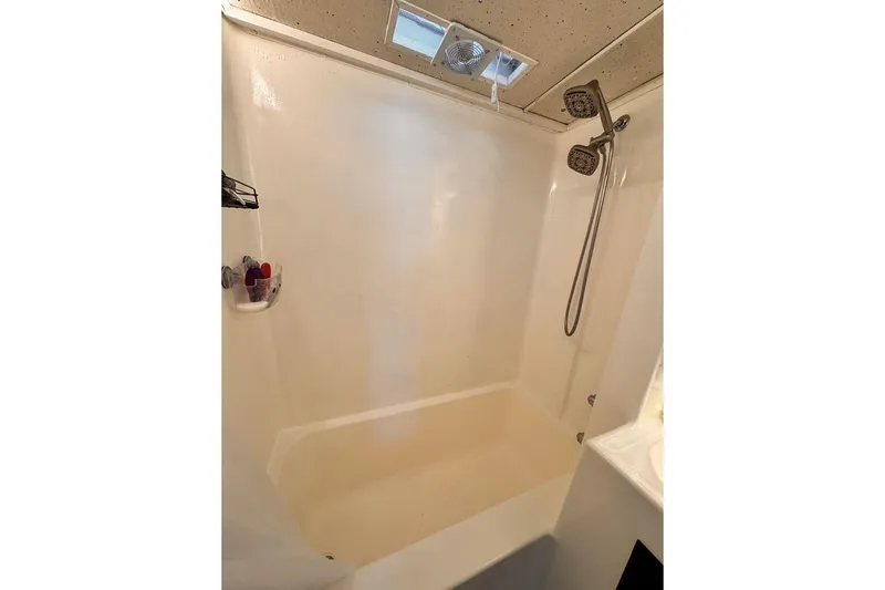 Slide: The Image of Shower area in 1984 Boatel Hercules boat with dual shower heads and ceiling vent. - 20