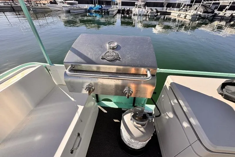 Slide: The Image of Outdoor grill on a 1984 Boatel Hercules boat docked at a marina. - 22