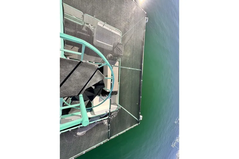 Slide: The Image of Aerial view of 1984 Boatel Hercules boat on calm green water. - 23