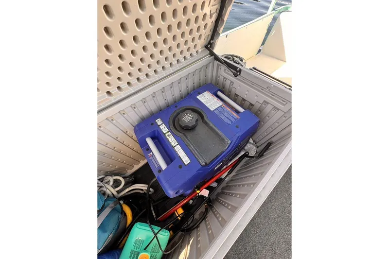 Slide: The Image of Blue generator inside a storage compartment on a 1984 Boatel Hercules boat. - 26