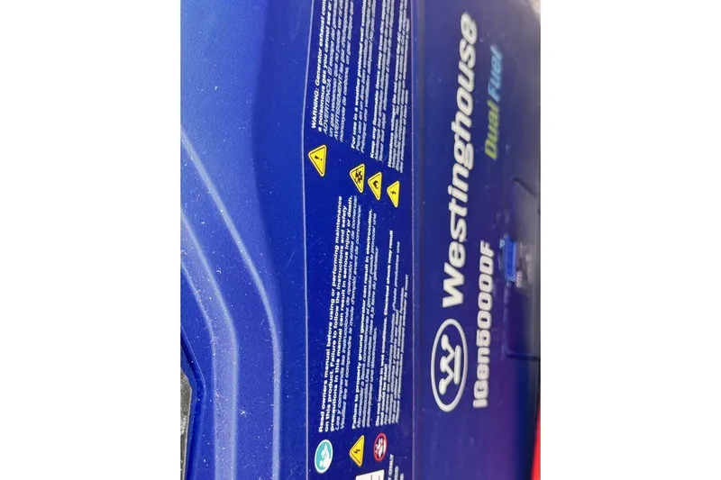 Slide: The Image of Blue Westinghouse iGen5000DF generator with safety warnings and dual fuel feature. - 27