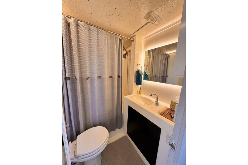 Slide: The Image of Compact bathroom in 1984 Boatel Hercules with shower, sink, and toilet. - 7