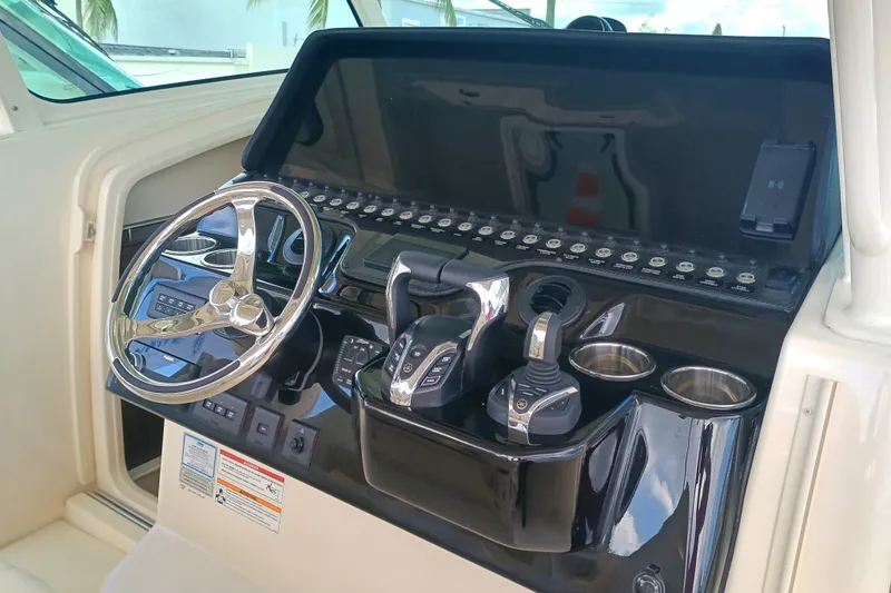 Slide: The Image of 2025 Grady-White Canyon 386 helm with steering wheel and control panel. - 10