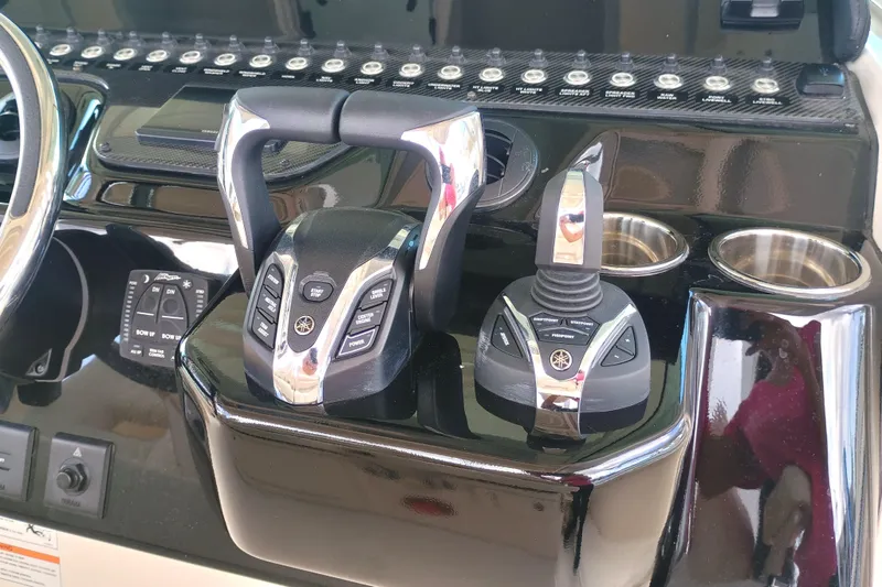 Slide: The Image of Control panel of 2025 Grady-White Canyon 386 boat with advanced throttle and joystick. - 11