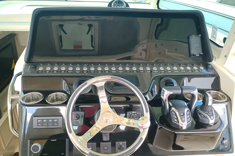 Slide: The Image of Helm of 2025 Grady-White Canyon 386 boat with modern controls and steering wheel. - 13