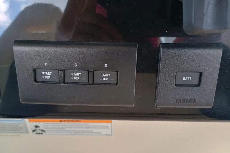 Slide: The Image of Control panel of a 2025 Grady-White Canyon 386 boat with Yamaha start-stop buttons. - 14