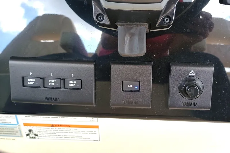 Slide: The Image of Control panel of a 2025 Grady-White Canyon 386 boat with Yamaha start-stop buttons. - 15