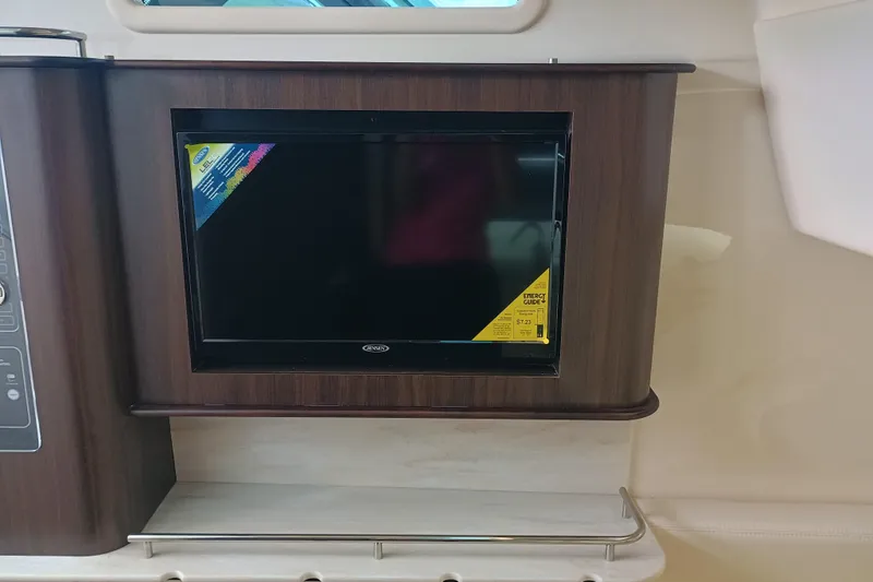 Slide: The Image of 2025 Grady-White Canyon 386 interior with built-in TV and wood paneling. - 21