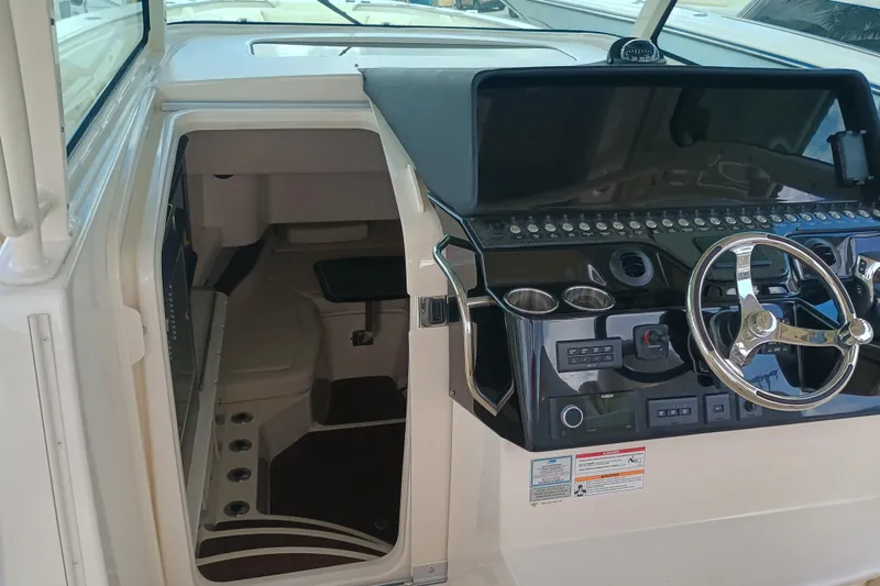 Slide: The Image of 2025 Grady-White Canyon 386 helm with modern controls and cabin entrance. - 28