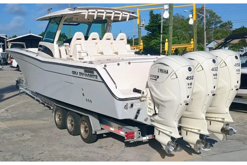 Slide: The Image of 2025 Grady-White Canyon 386 boat with triple Yamaha 450 V8 engines on trailer. - 5