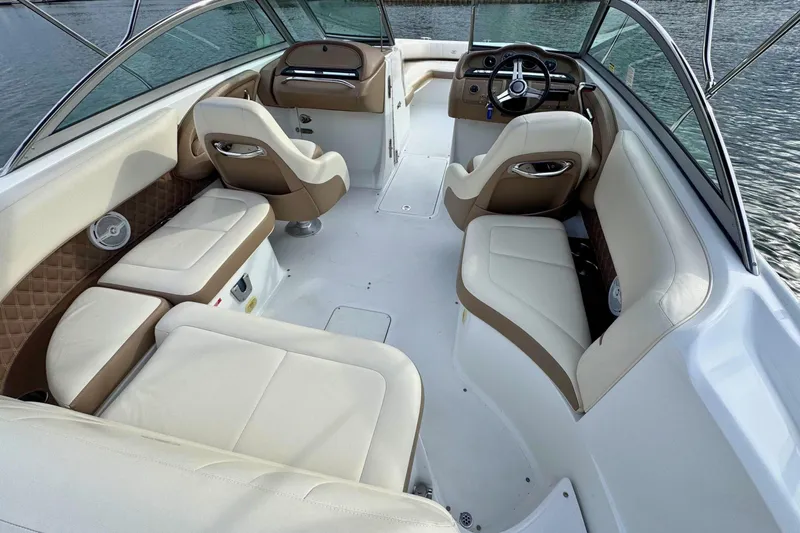 Slide: The Image of Interior of a 2010 Cobalt 242 boat with luxurious seating and steering wheel. - 11