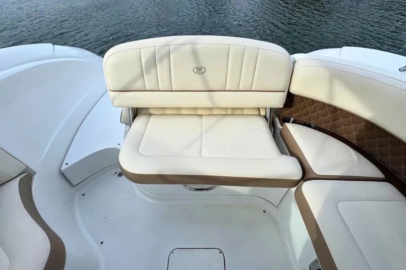 Slide: The Image of Luxurious seating on a 2010 Cobalt 242 boat, featuring elegant white and brown upholstery. - 14