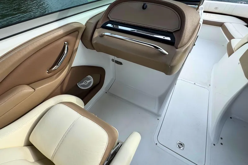 Slide: The Image of Interior of a 2010 Cobalt 242 boat with beige and white seating. - 16
