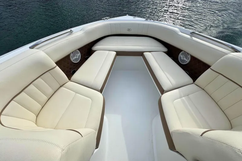 Slide: The Image of Luxurious seating on a 2010 Cobalt 242 boat with cream upholstery and water backdrop. - 22