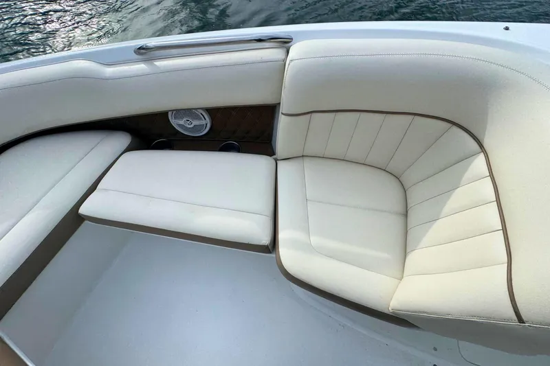 Slide: The Image of Luxurious seating on a 2010 Cobalt 242 boat with white upholstery. - 23