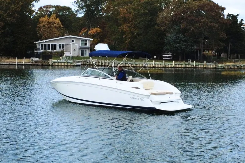 Slide: The Image of 2010 Cobalt 242 boat on a lake near a house with autumn trees. - 5